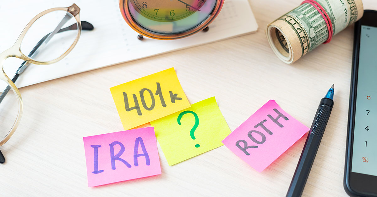 Sticky notes with "IRA," "401(k)," "ROTH," and a question mark, surrounded by financial items like glasses, cash, and a calculator.