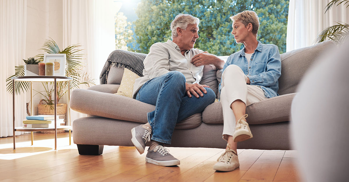 Thoughtful older couple discussing their financial future, guided by a Family Office Director from Financial Gravity.
